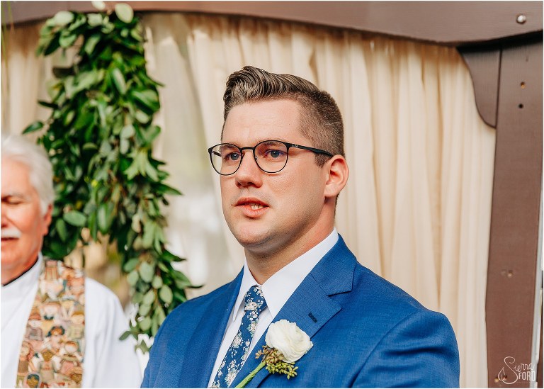 groom bites lip as he gets emotional seeing bride for first time at Disney themed garden wedding ceremony