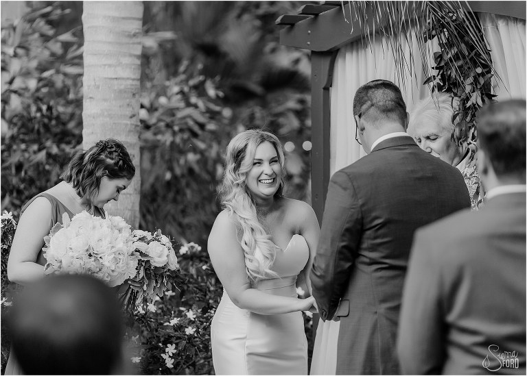 bride laughs during Disney themed garden wedding ceremony