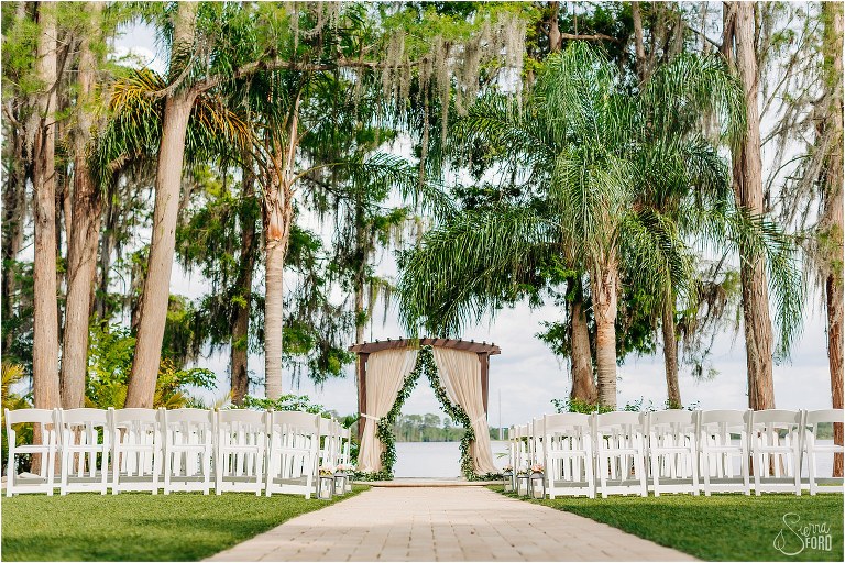 Paradise Cove ceremony site under massive trees at Disney themed garden wedding