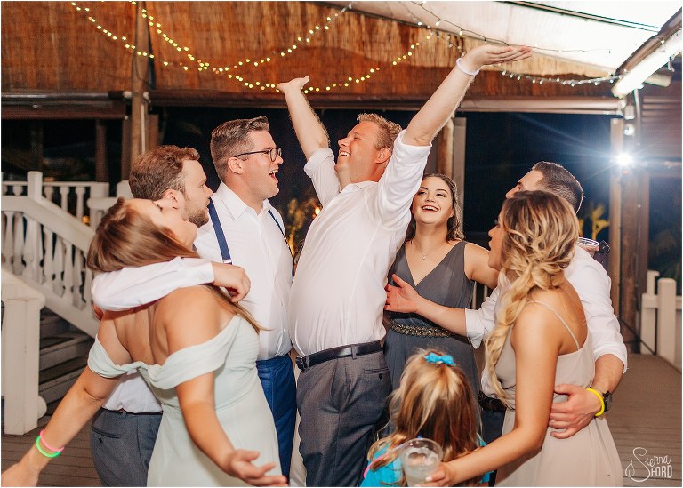 guest spins in middle of group hug during final dance at Disney themed garden wedding reception
