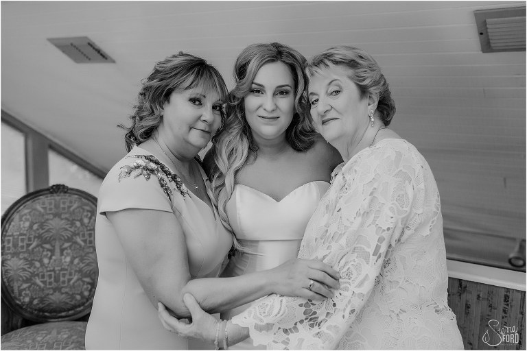 mother & grandmother hug bride before Disney themed garden wedding