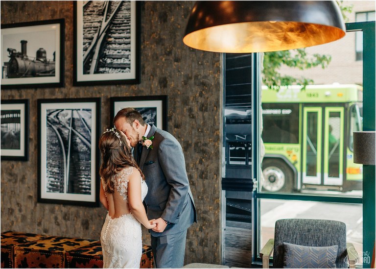 bride & groom kiss before Savannah elopement in Hilton Garden Inn lobby