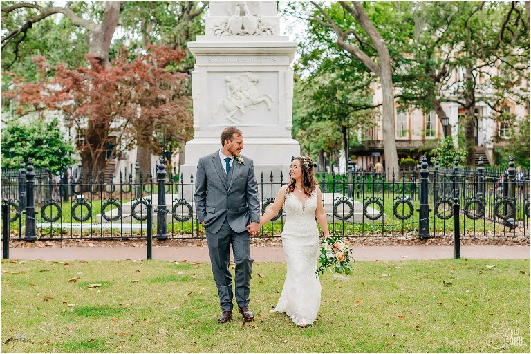 bride & groom stroll hand in hand through Monterey Square after Savannah elopement