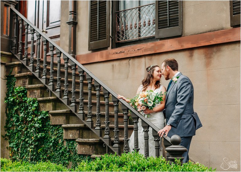 bride & groom nuzzle noses on stairs at Savannah elopement