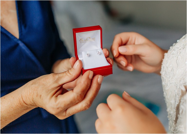 mom presents bride with small diamond earrings before Savannah elopement