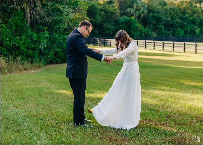 bride shows off her yellow Seychelle's shoes to groom before elegant backyard elopement