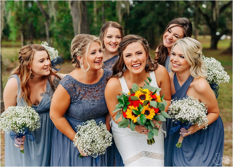 bride laughs with her bridesmaids in periwinkle bridesmaids dresses at DIY Florida Barn Wedding