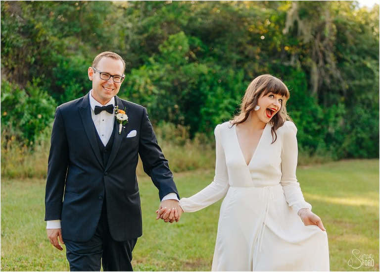 bride & groom goof off together after elegant backyard elopement