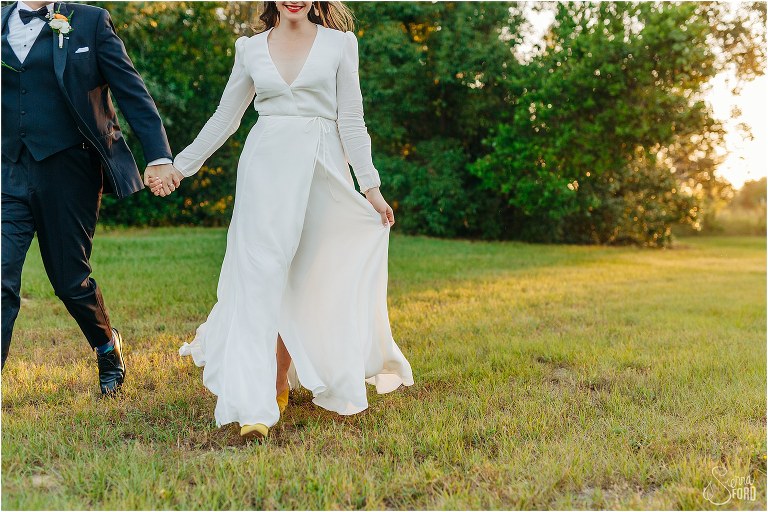 bride & groom run through yard at sunset at elegant backyard elopement