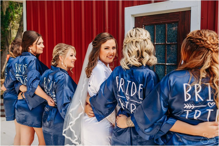 bride laughs with her bridesmaids before DIY Florida Barn Wedding in Tavares