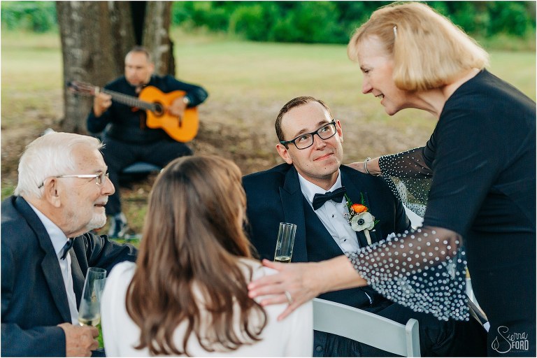 mother of the groom chats with guests at elegant backyard elopement