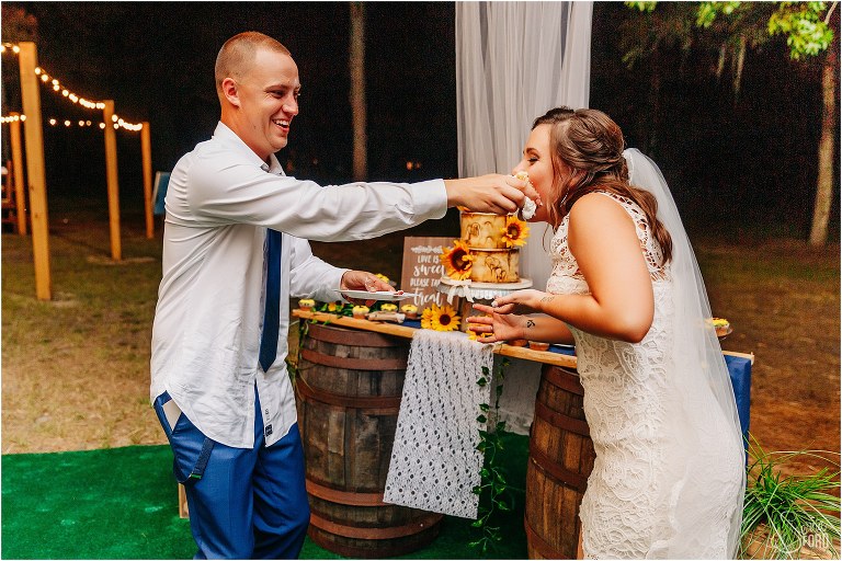 groom stuffs Grubby Cakes cupcake into bride's face at DIY Florida Barn Wedding reception