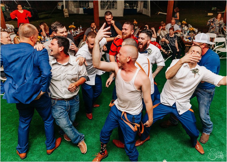 groom and his boys throw down for a mosh pit at DIY Florida Barn Wedding reception