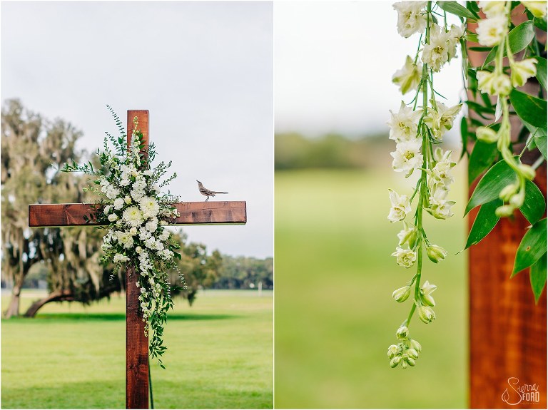 on left, little bird checks out Miss Daisy's white & green spray arrangement on ceremony cross, on right, cascading white flowers on cross at Wildwood wedding
