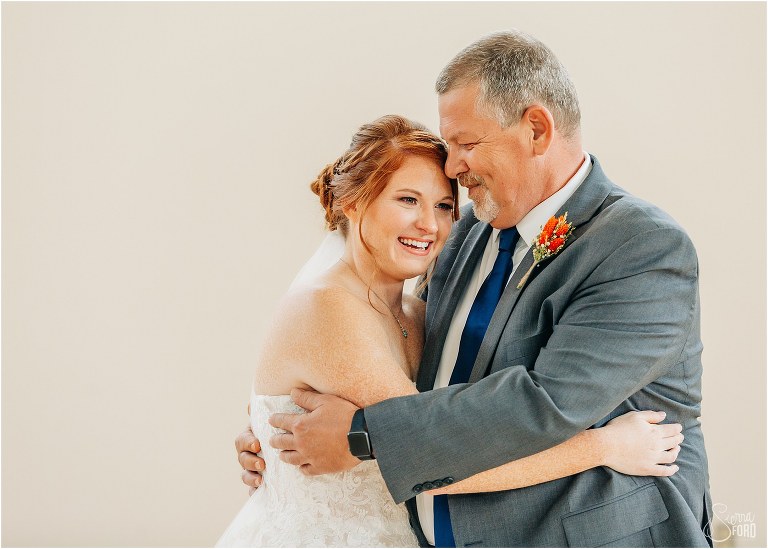 bride laughs as she hugs her father before Wildwood wedding