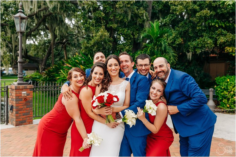 the wedding party gives bride & groom a group hug at waterfront wedding