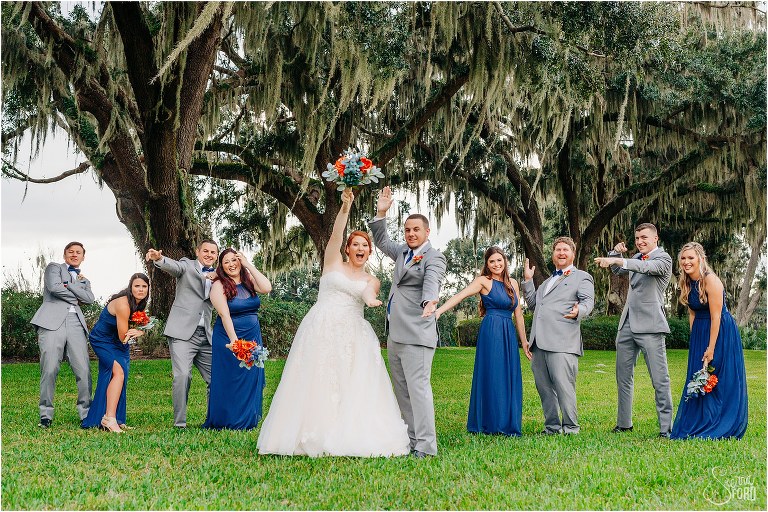 bride & groom gator chomp surrounded by wedding party at Wildwood wedding