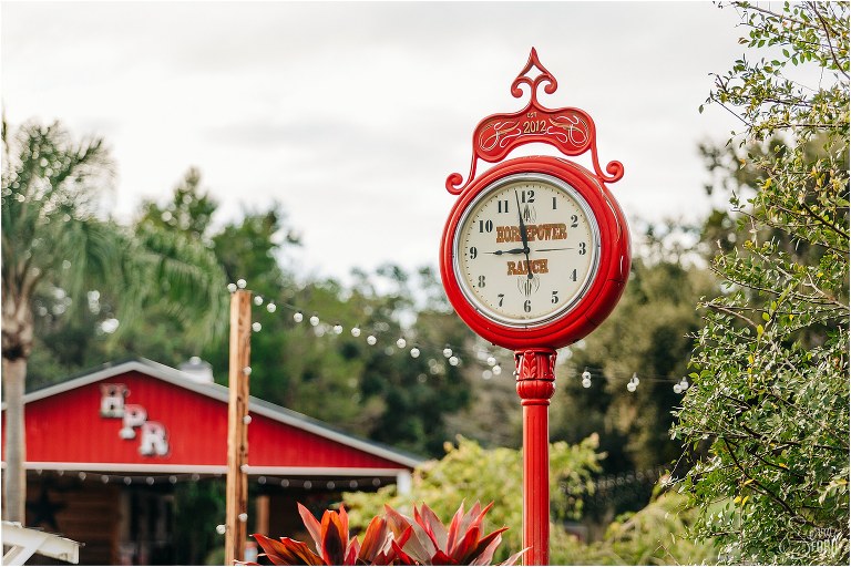 giant red clock at Horsepower Ranch wedding