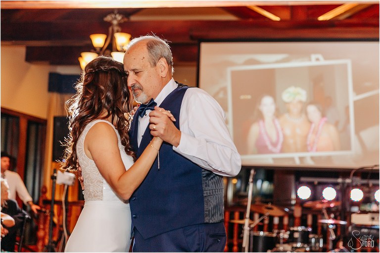 father shares emotional moment with daughter during dance at waterfront wedding reception