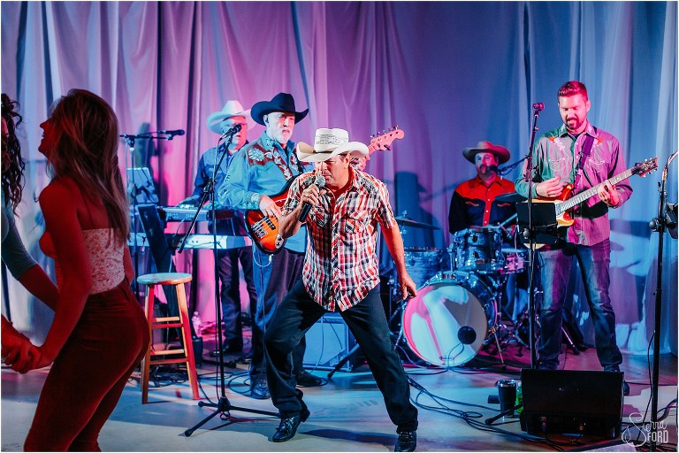 lead singer of JKS Production band shows off dance moves at Horsepower Ranch wedding
