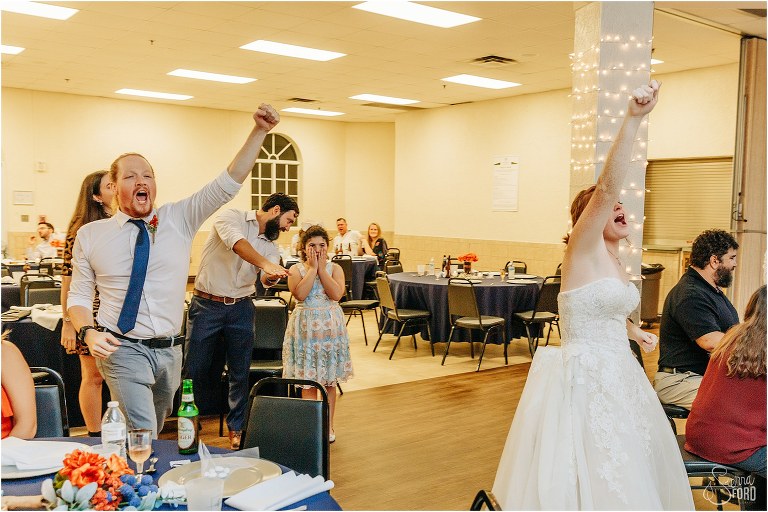 bride & her brother enthusiastically yell during Florida Gators Two Bits cheer at Wildwood wedding reception