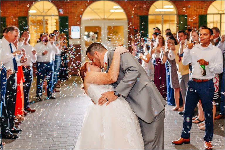 groom dips bride during bubble grand exit at Wildwood wedding