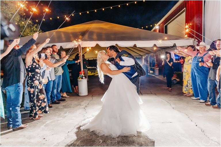 bride & groom kiss during sparkler exit at Horsepower Ranch wedding