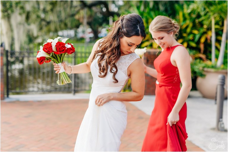 bride checks dress as she walks into Tavares Pavilion for waterfront wedding