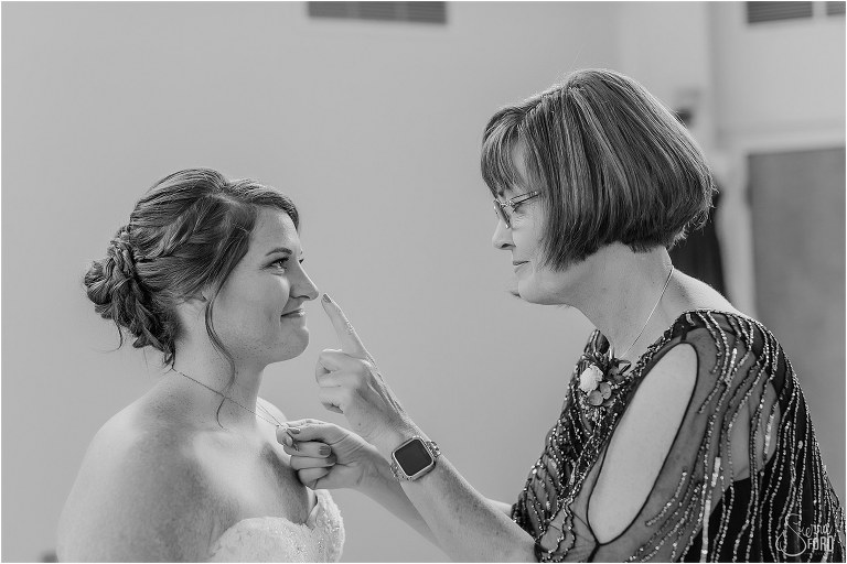mother of the bride boops bride on nose as she helps get her ready before Wildwood wedding