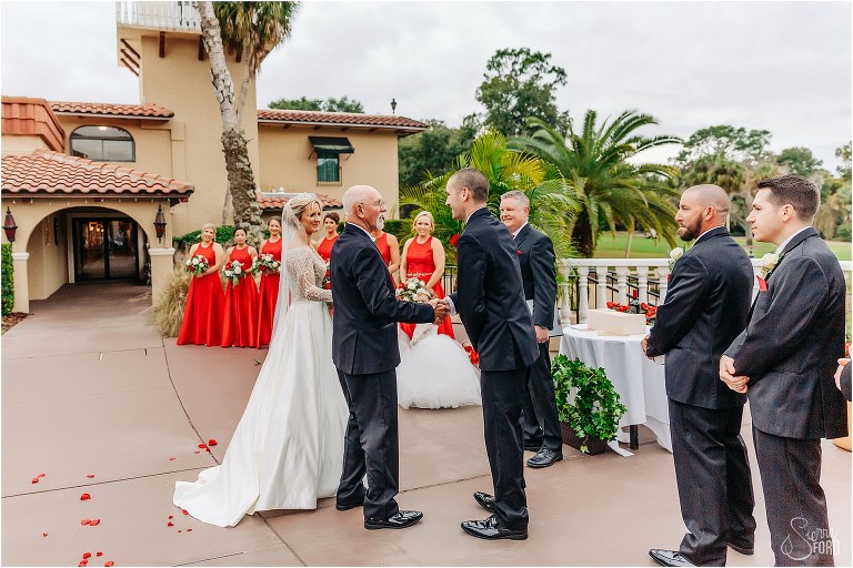 groom shakes hand of father of the bride at Mission Inn Resort wedding ceremony