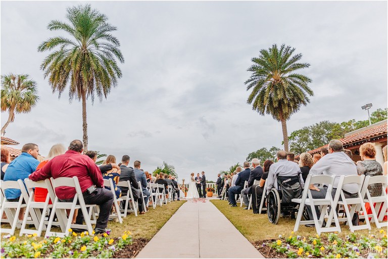bride & groom exchange vows under palm trees at Mission Inn Resort wedding ceremony