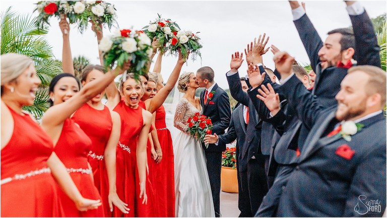 wedding party cheers as bride & groom kiss at Mission Inn Resort wedding
