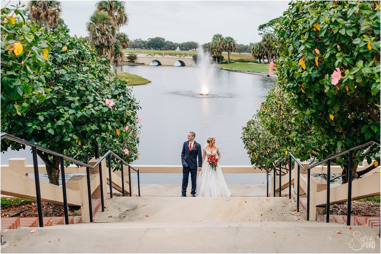 bride & groom look off into distance at bottom of staircase at Mission Inn Resort wedding