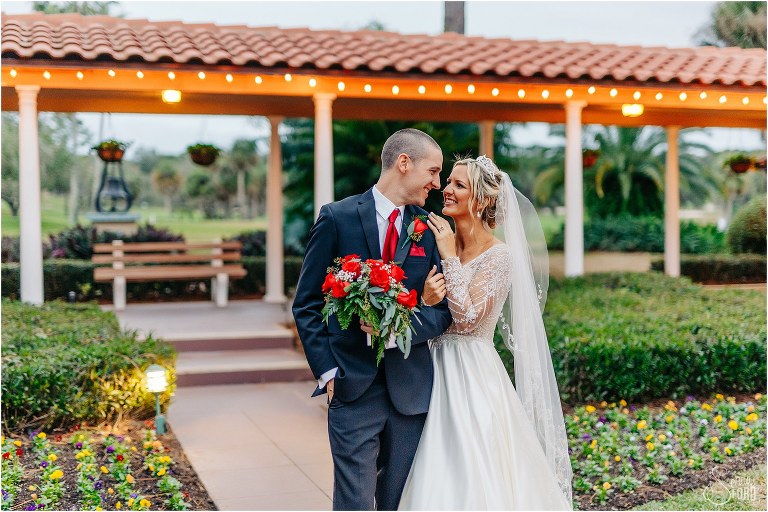 bride & groom cozy up in courtyard at Mission Inn Resort wedding with market lights behind them