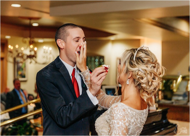 bride smashes red velvet wedding cake into groom's nose at Mission Inn Resort wedding reception
