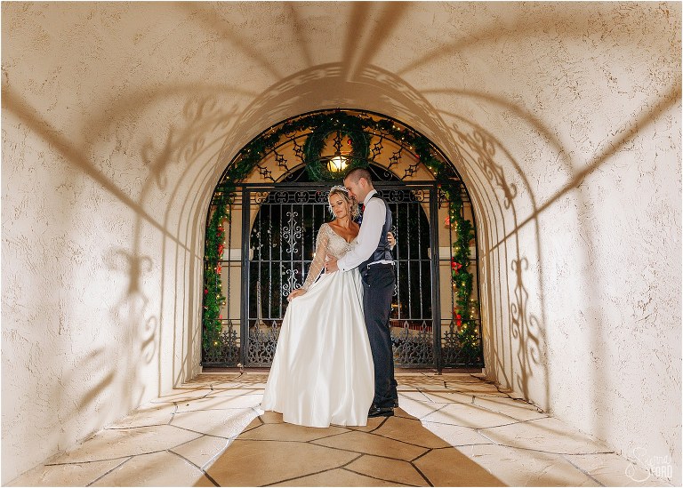 dramatic shadows surround bride & groom in archway at Mission Inn Resort wedding