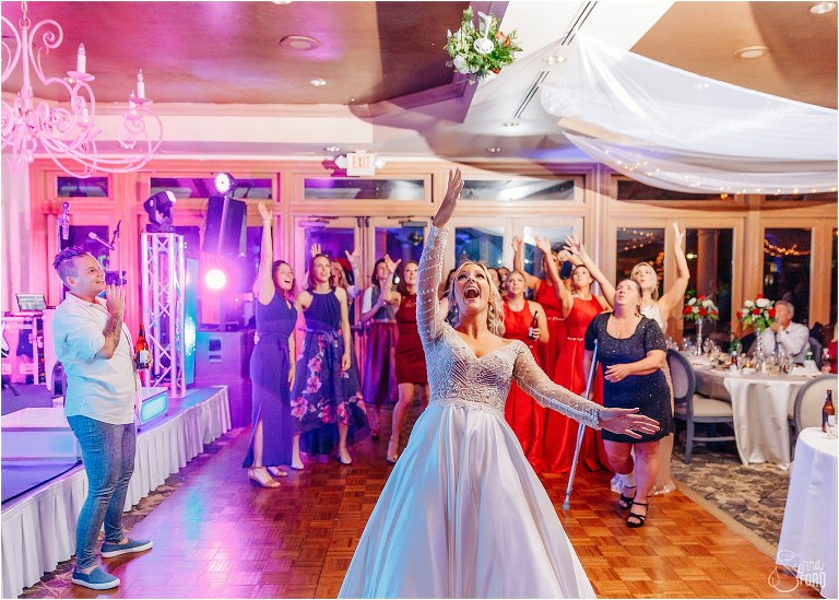 bride releases bouquet as her single ladies try to catch it at Mission Inn Resort wedding