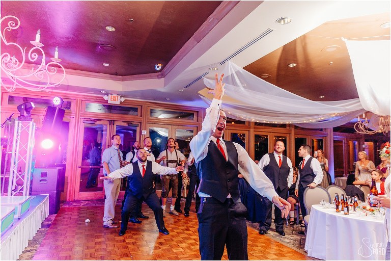 the single men jump for the bride's garter at Mission Inn Resort wedding