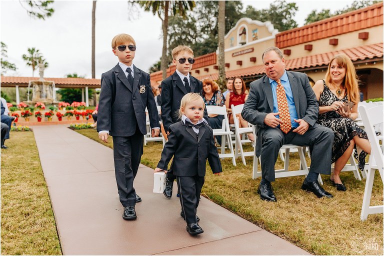 older nephews act as ring security and escort ring bearer down aisle at Mission Inn Resort wedding