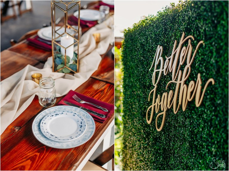 left, mismatched vintage plates for place settings, right, greenery wall stating "better together" at Isola Farms wedding