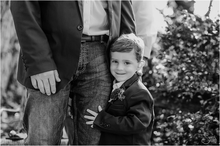 bride & groom's son hugs groom's leg before Isola Farms wedding