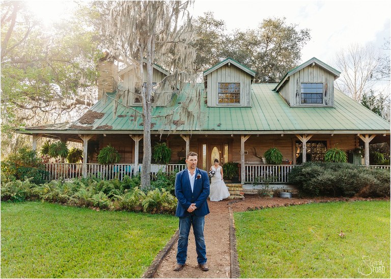 groom waits in front of main house to see his bride for first time before Isola Farms wedding
