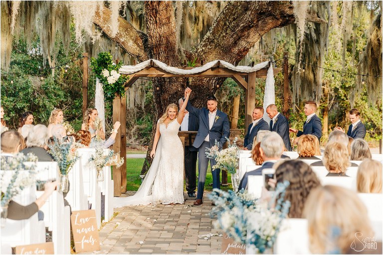 bride and groom cheer as they are introduced as husband and wife at Ever After Farms wedding