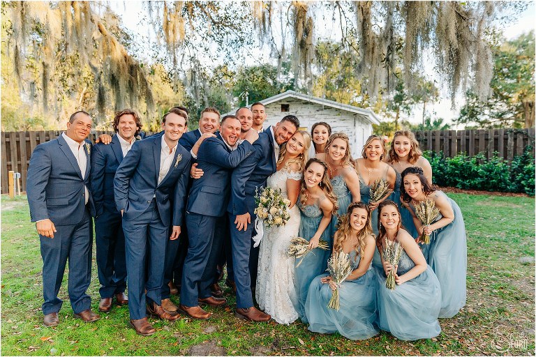 wedding party gives bride and groom a group hug at Ever After Farms wedding