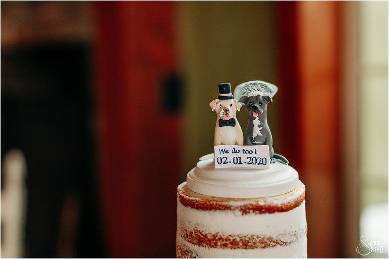 personalized cake topper featuring bride and groom's dogs at lakefront wedding