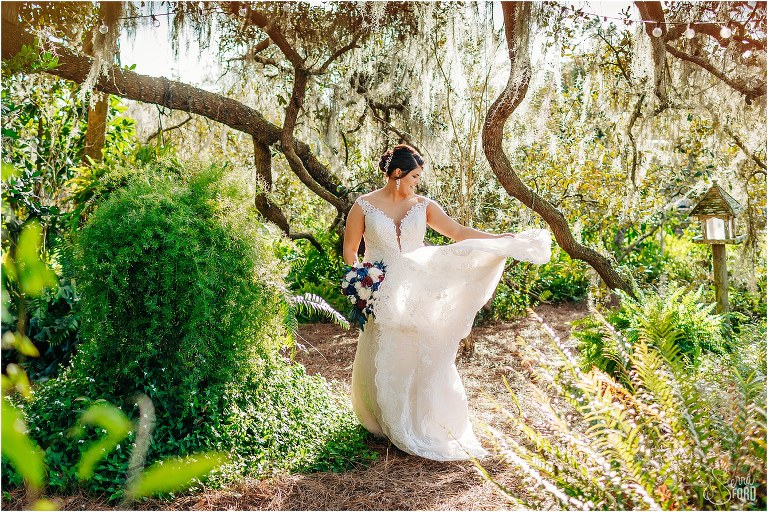 bride twirls her Maggie Sottero wedding gown under the oak trees at Isola Farms wedding