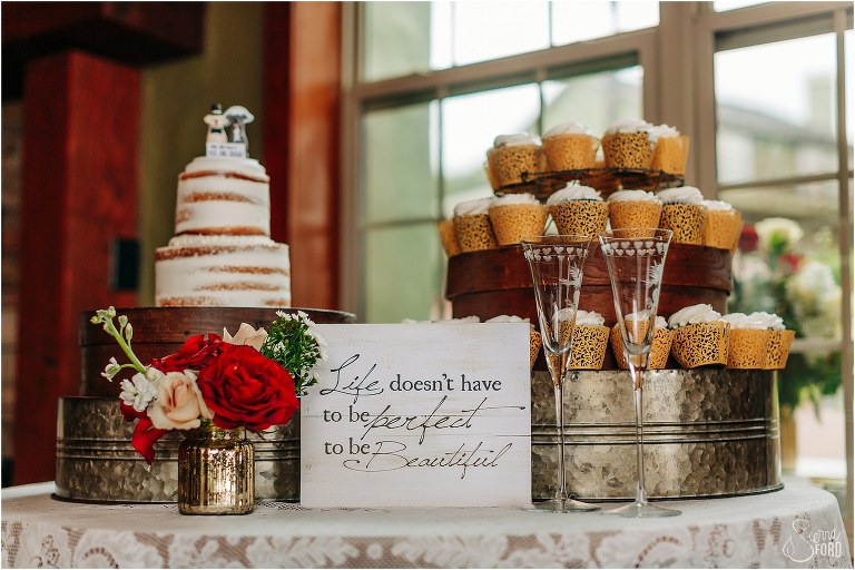 dessert table with cake and cupcakes at lakefront wedding