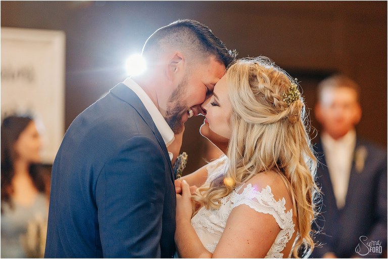 bride and groom smile right before they kiss during first dance at Ever After Farms wedding
