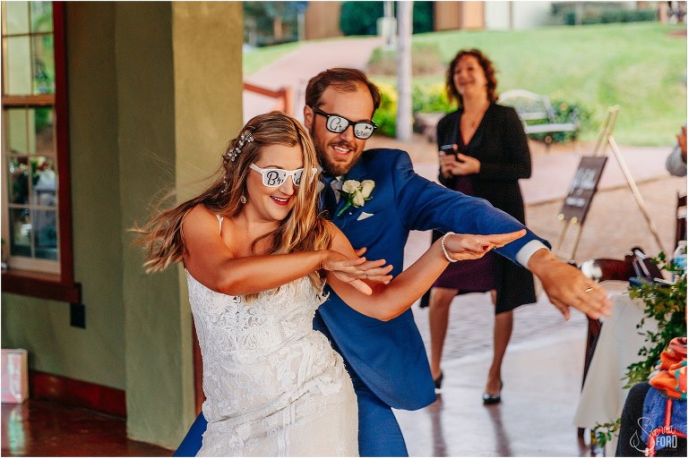 bride and groom bust a move as they are introduced at lakefront wedding reception