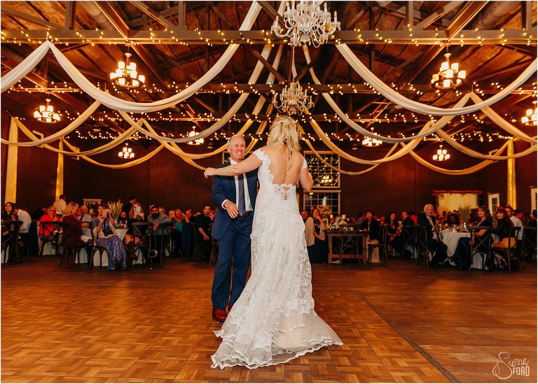 stepfather of the bride joins bride for dance under chandeliers at Ever After Farms wedding